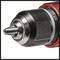 Close-up of a black cordless drill's chuck with red accents, showing metallic details and robust construction.