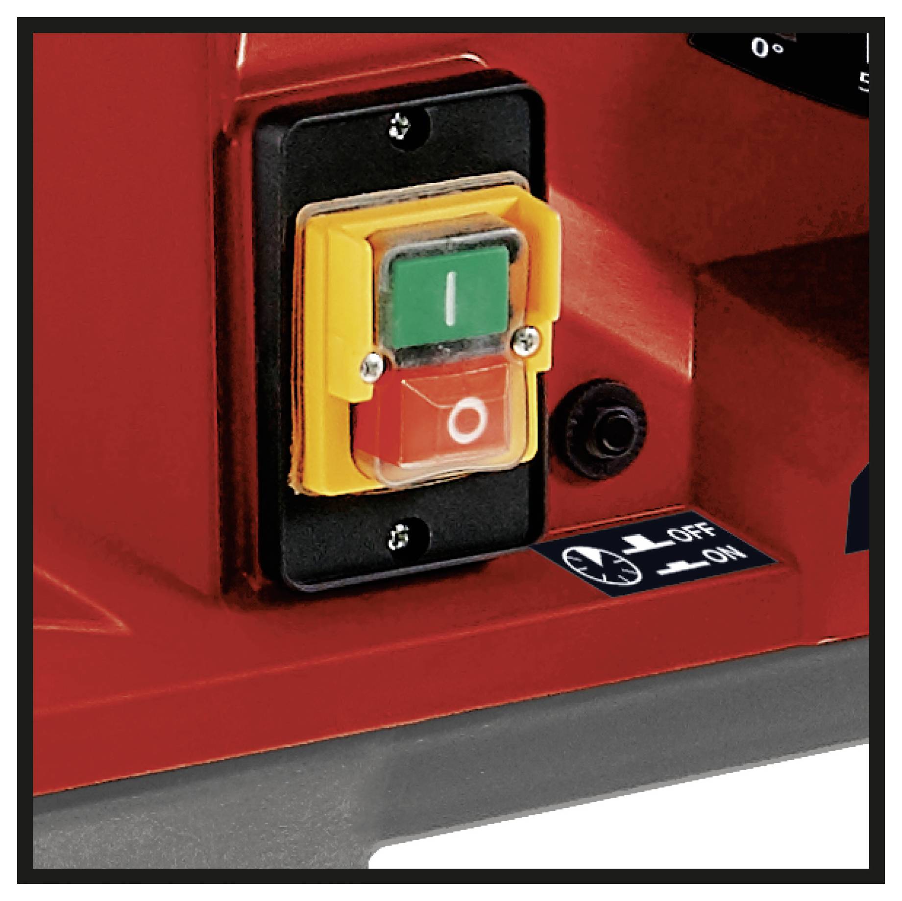 Red and green power switch on a red machine, with black panel and 'OFF ON' label, indicating machine control function.