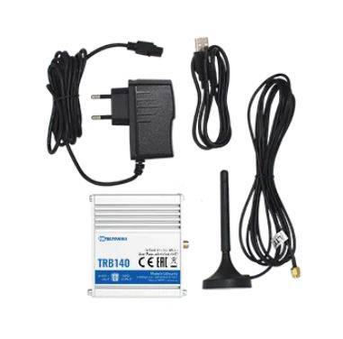 A gateway device with antenna, power supply and cables. Model 'TRB140'. Used for network connectivity.