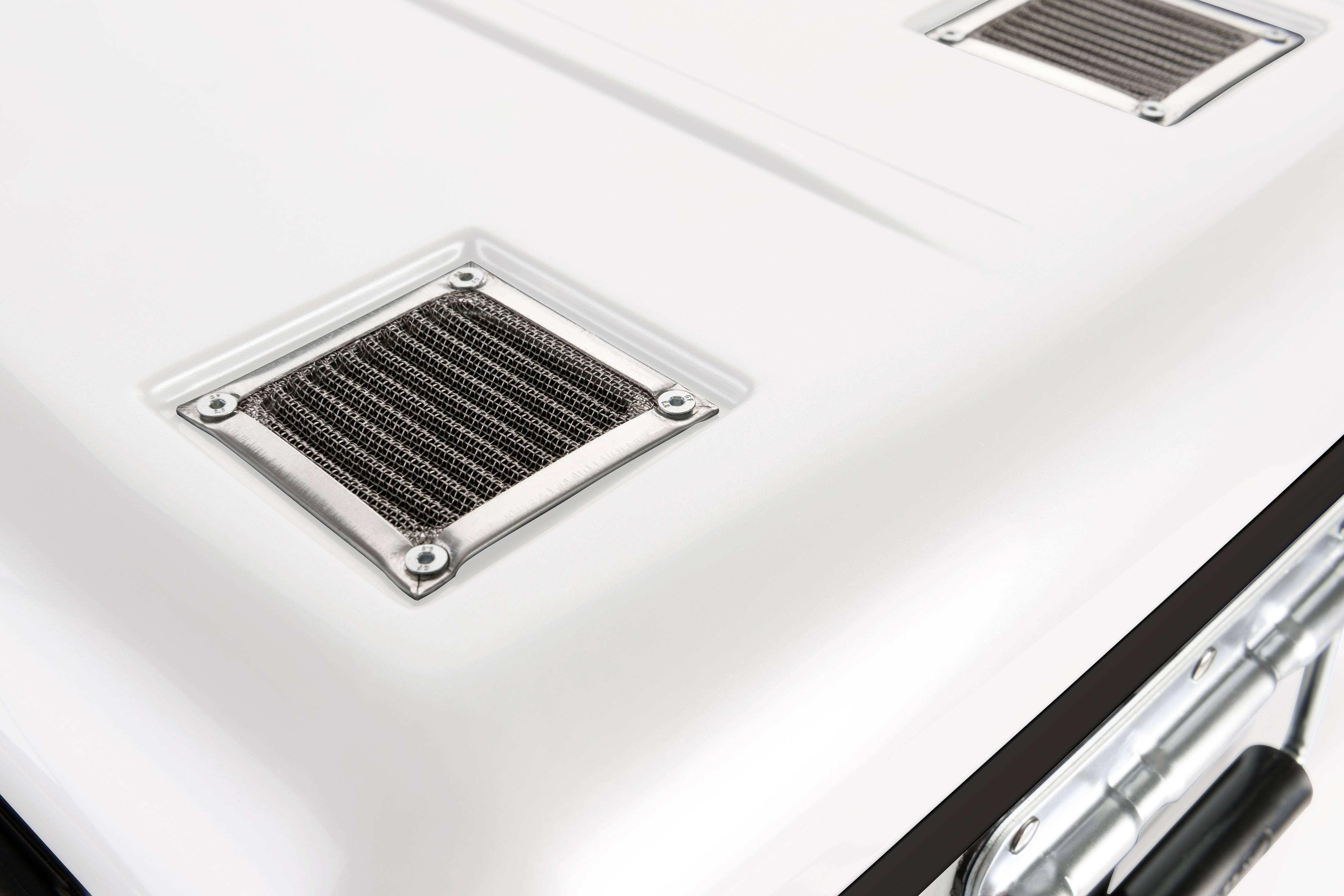 A close-up of a white vehicle with two rectangular air intakes on the bonnet.