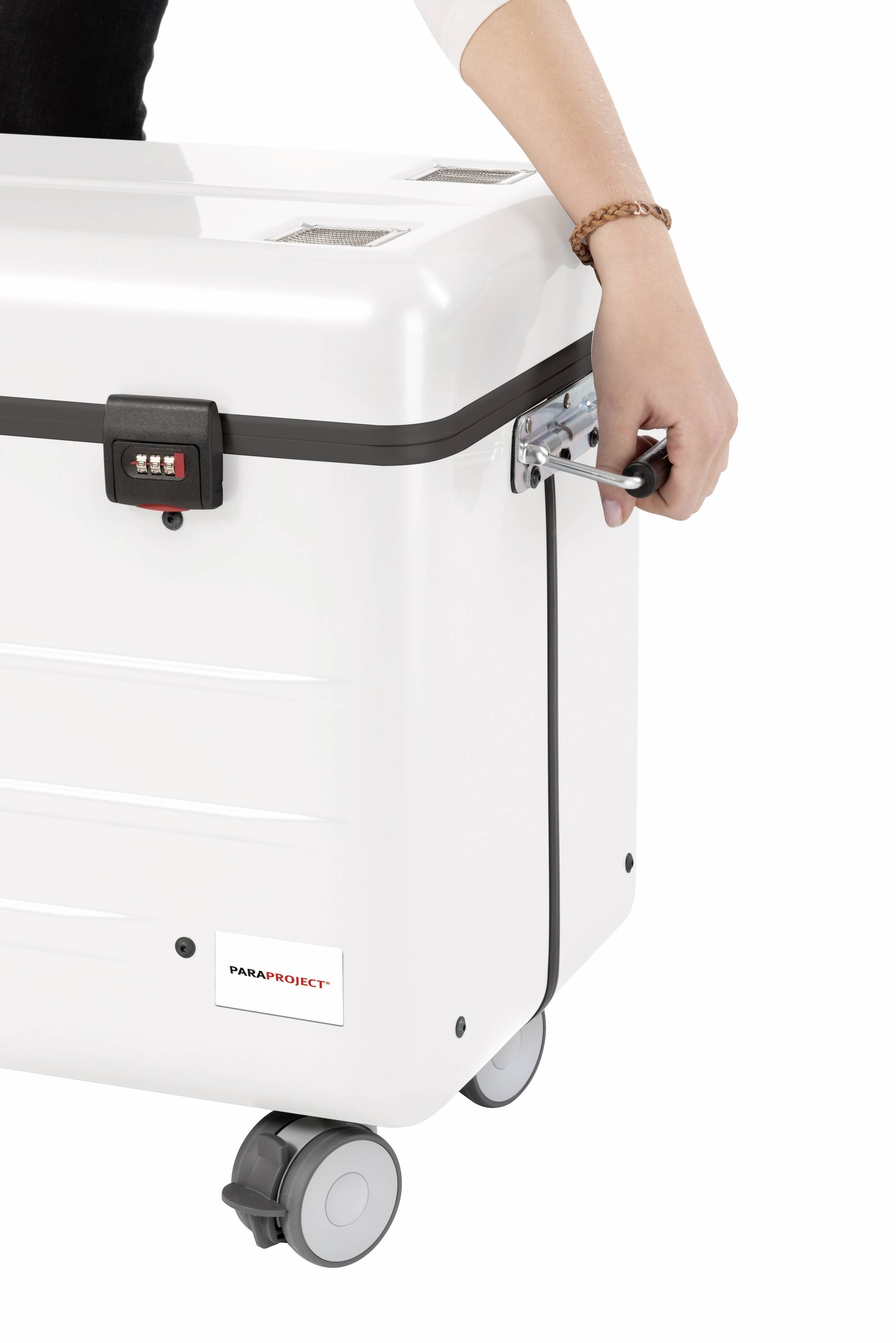 A person is pulling a white suitcase with a combination lock. The suitcase has four wheels and a silver handle.