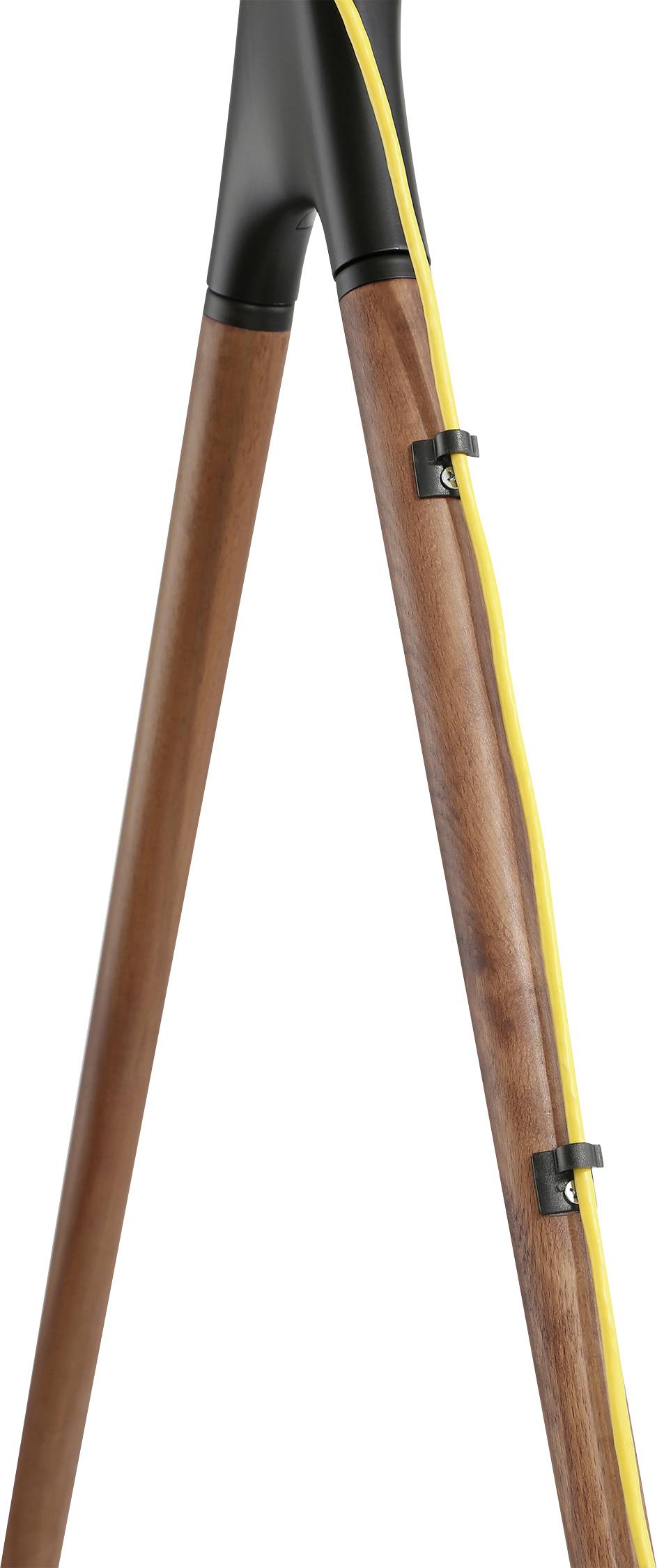 Wooden tripod of a standard lamp with a yellow cable running along its exterior. The cable is secured by black clips.