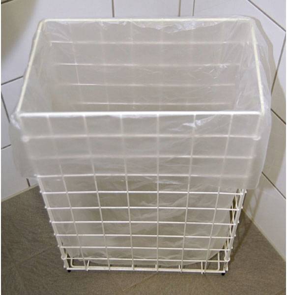 Metal bucket with a plastic liner in a tiled and linoleum corner.