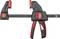 A black Bessey clamp with red handles, used for securing workpieces.