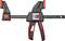 A black and red G-clamp with handles and an adjustable rail for securing materials. Brand name on the clamp.