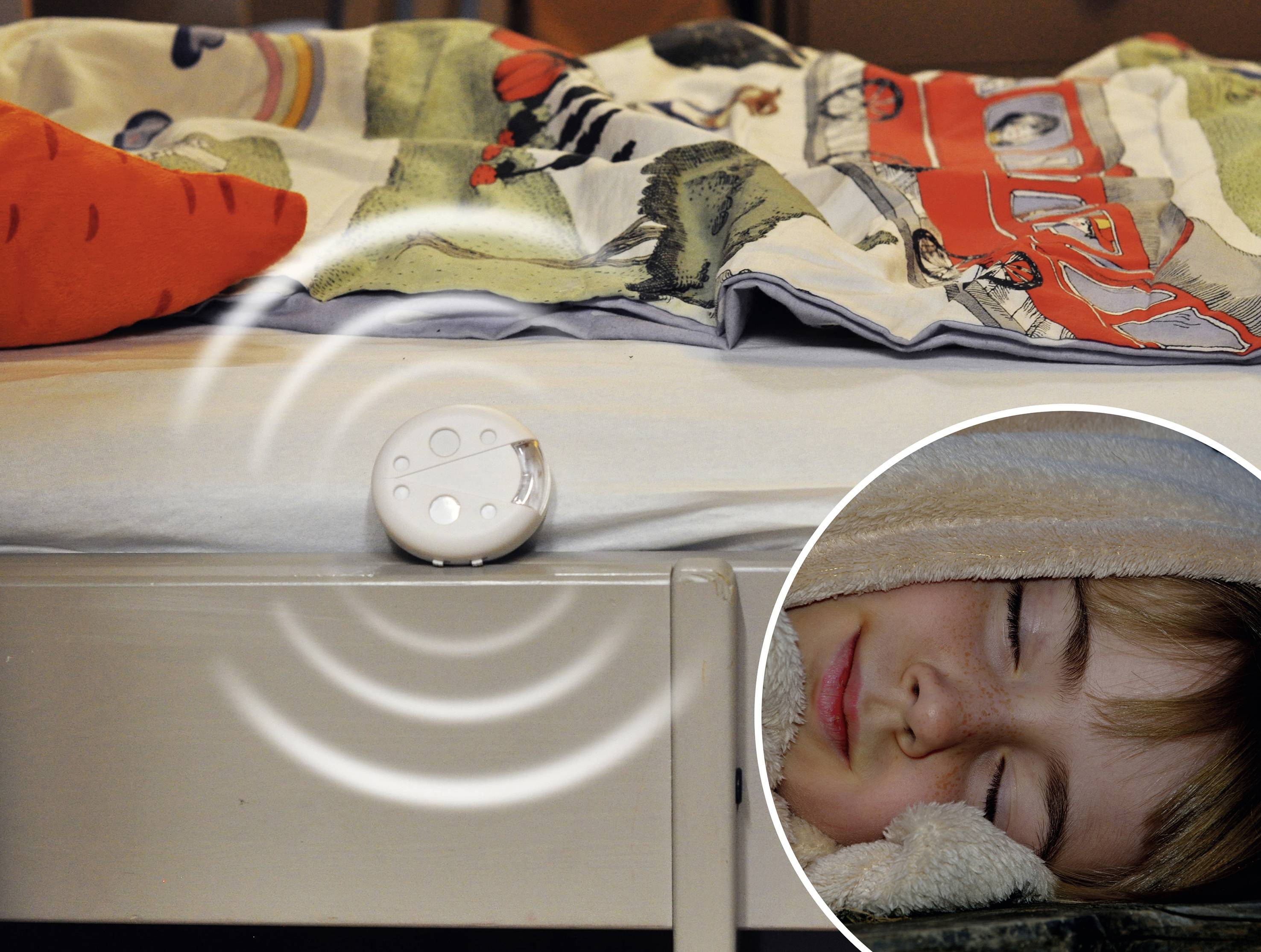 An alarm clock on a bed emits sound waves. A child sleeps peacefully beside it.