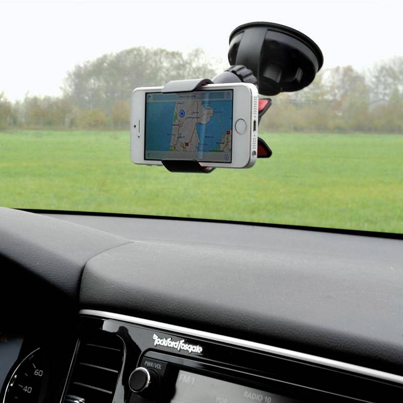 Smartphone in a windscreen mount showing a navigation map.
