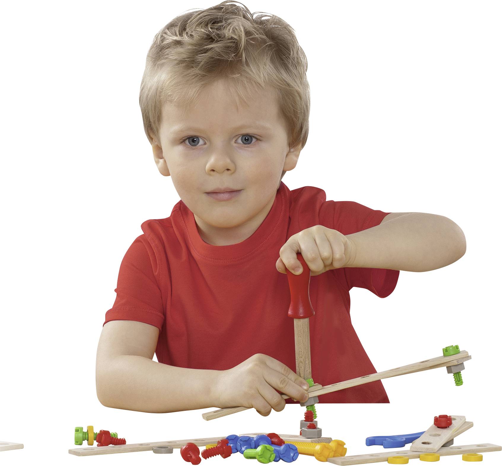 A child in a red shirt is playing intently with a wooden construction set, using a screwdriver to assemble parts.