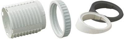 Four differently shaped plastic rings in various colours, which are possibly intended for a technical or mechanical application.