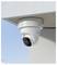 Security camera mounted on a building ceiling, facing downward.