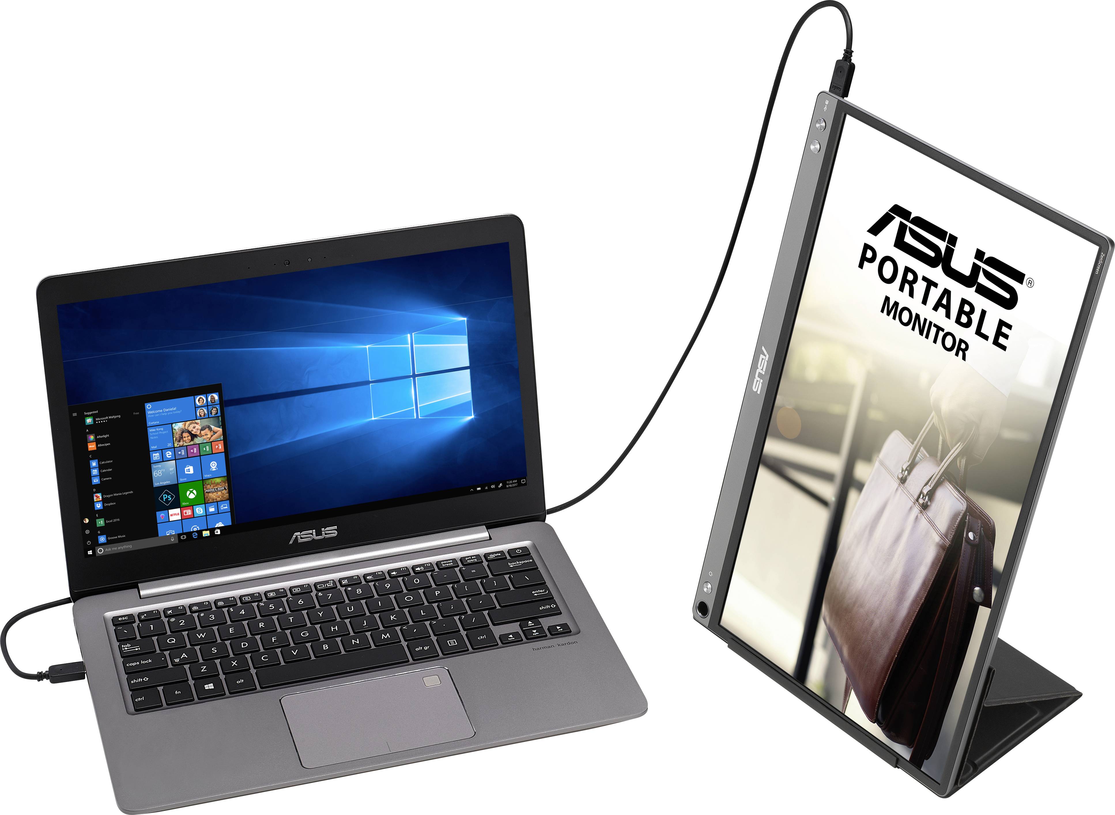 A laptop is connected to a portable monitor via a cable. The monitor displays the Asus logo and an image of a bag.