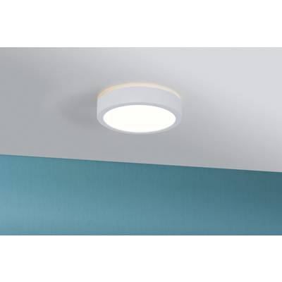 A round, white ceiling light casts bright light onto a blue-painted wall.