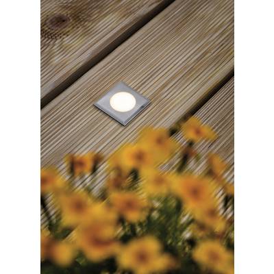 A square LED recessed light is set into a wooden decking. Yellow flowers are blurred in the foreground.