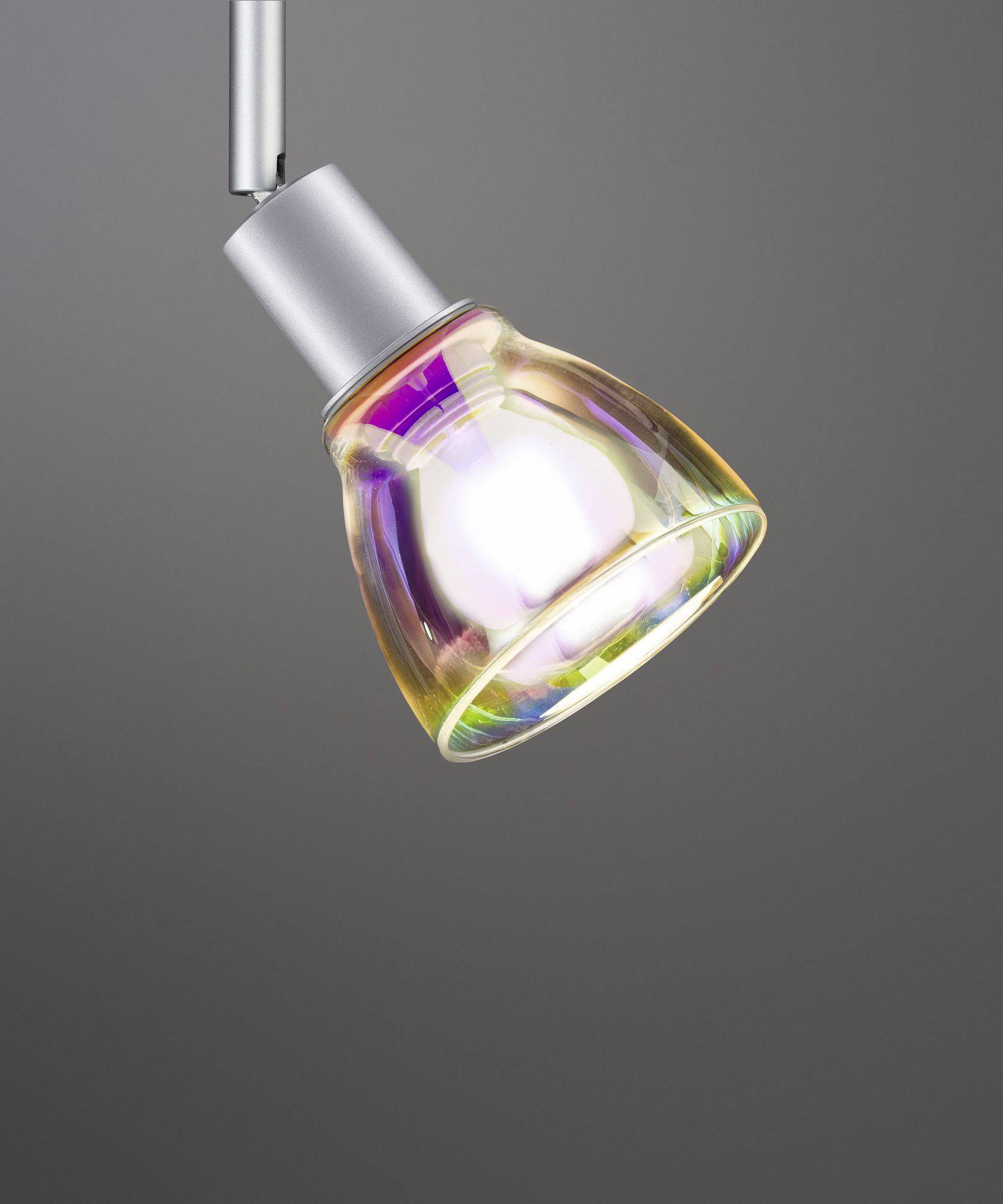 Iridescent swinging light bulb against a grey background, glowing in vibrant colours.