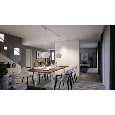 Modern dining area in an open-plan living space with a wooden table, white chairs and pendant lights. Plants and artworks are visible in the background.