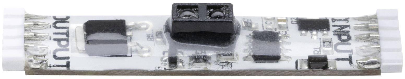 Close-up of an electronic circuit board with labels "INPUT" and "OUTPUT". Components are mounted on a small, narrow printed circuit board.