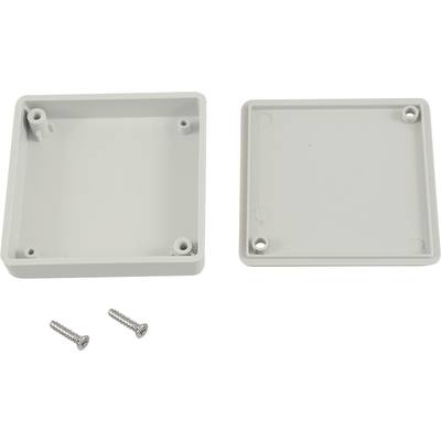 White plastic casing cover, square, removed, with four mounting holes. Two matching screws beside it.