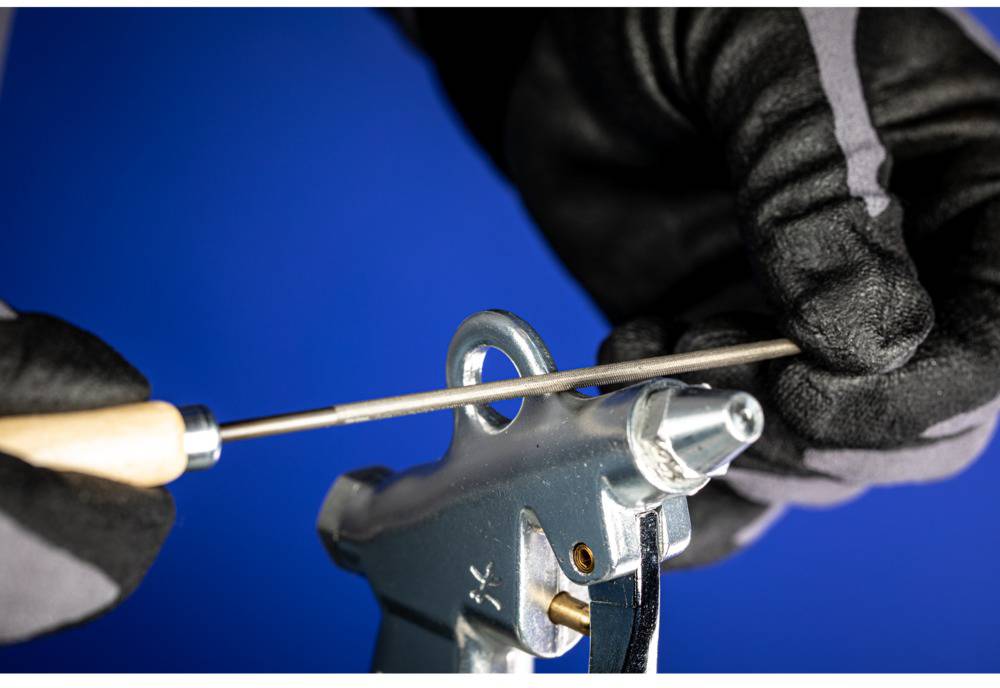 A person is mimicking the sound of a chainsaw being filed, wearing black gloves.