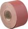 Roll of red sandpaper, lying on its side.