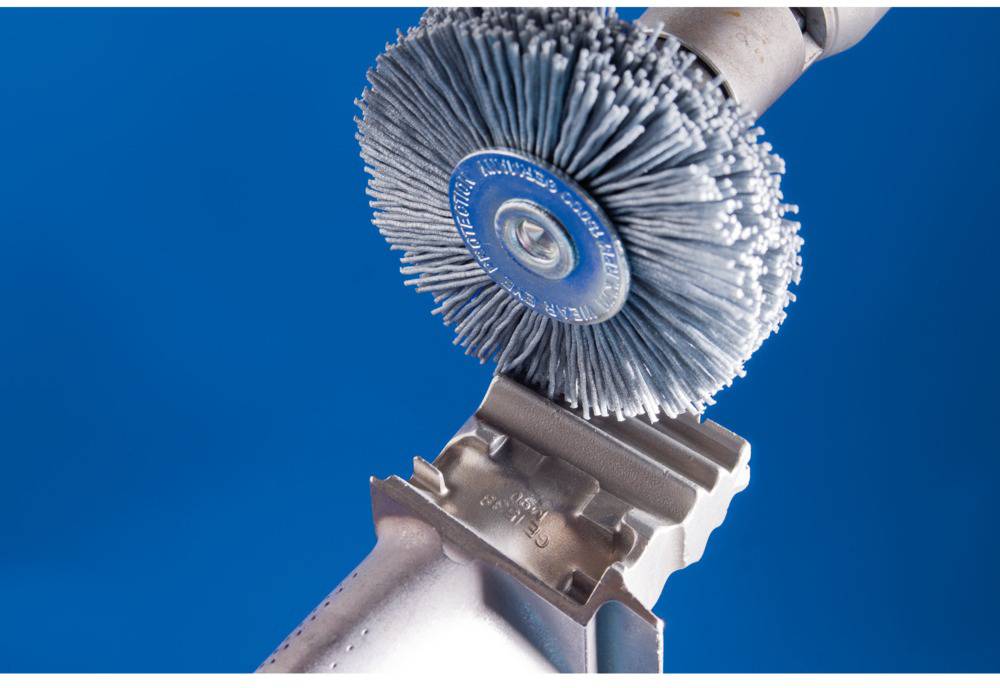 Radial brush polishes metal surface