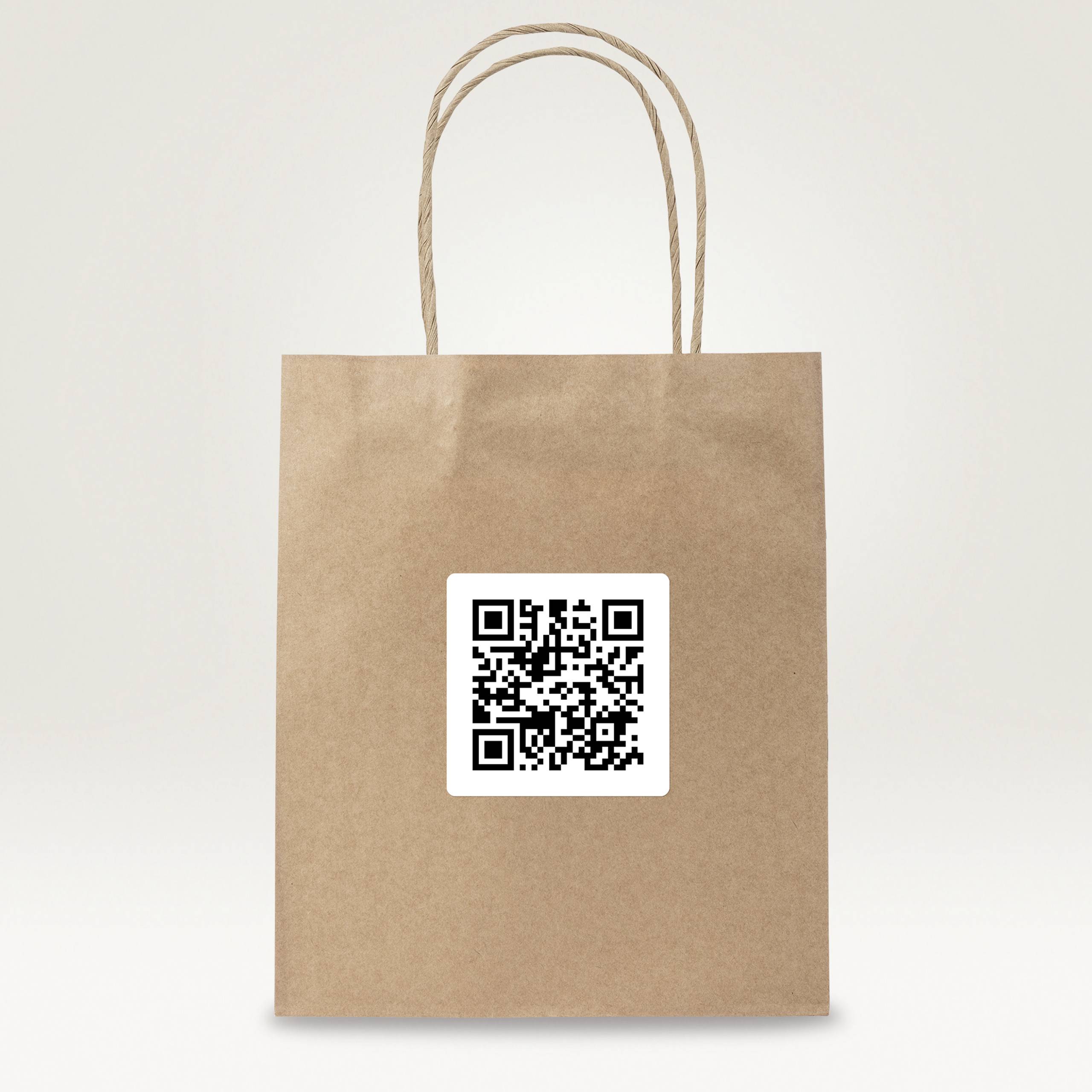 A brown paper bag with a large QR code on the front, inviting scanning.