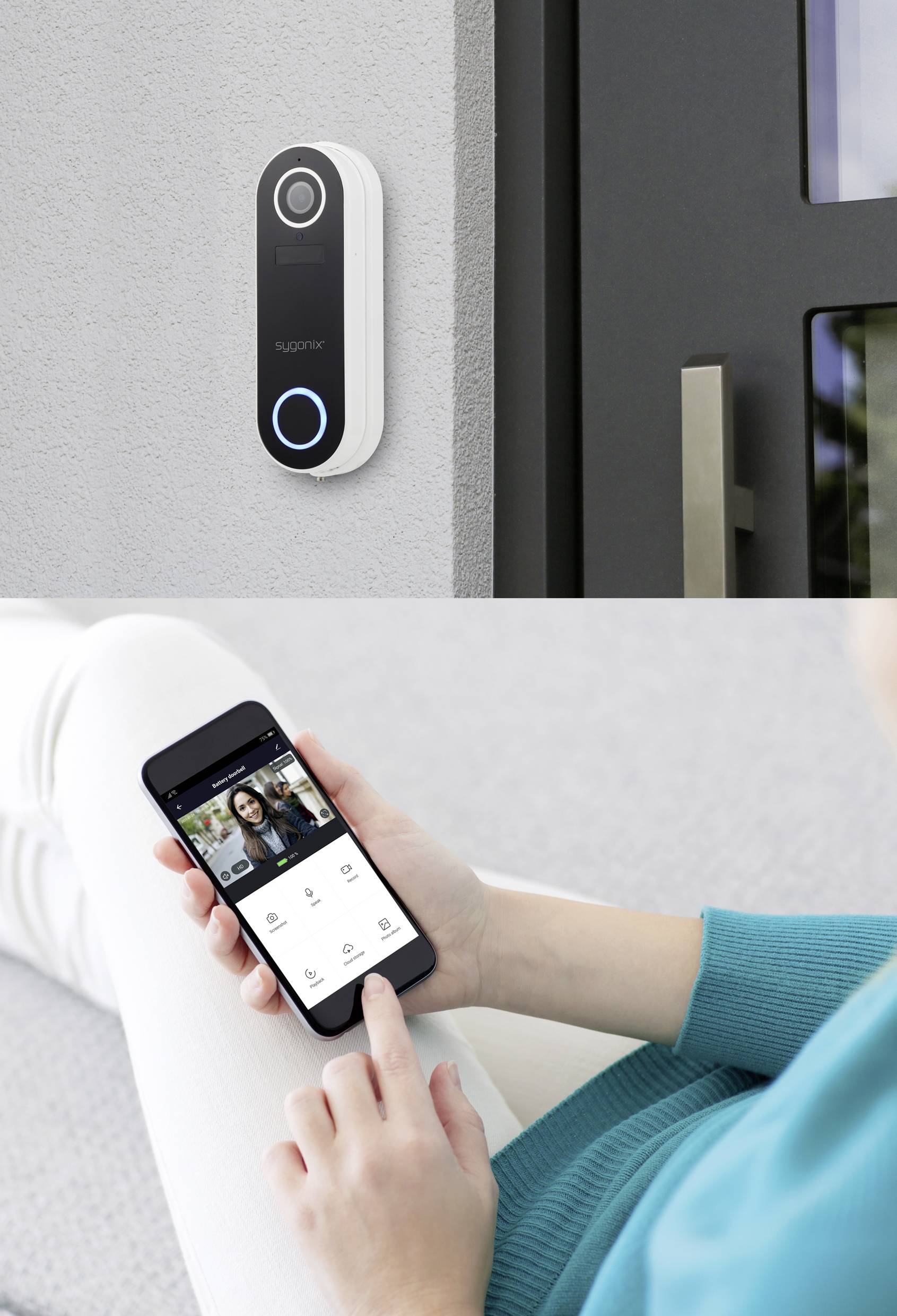 A person is sitting, holding a smartphone and checking the live feed from the doorbell camera. The smart doorbell is mounted on the wall.