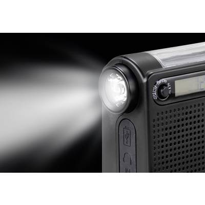 A portable black radio with a built-in torch glows brightly. A partial number is visible on a display.