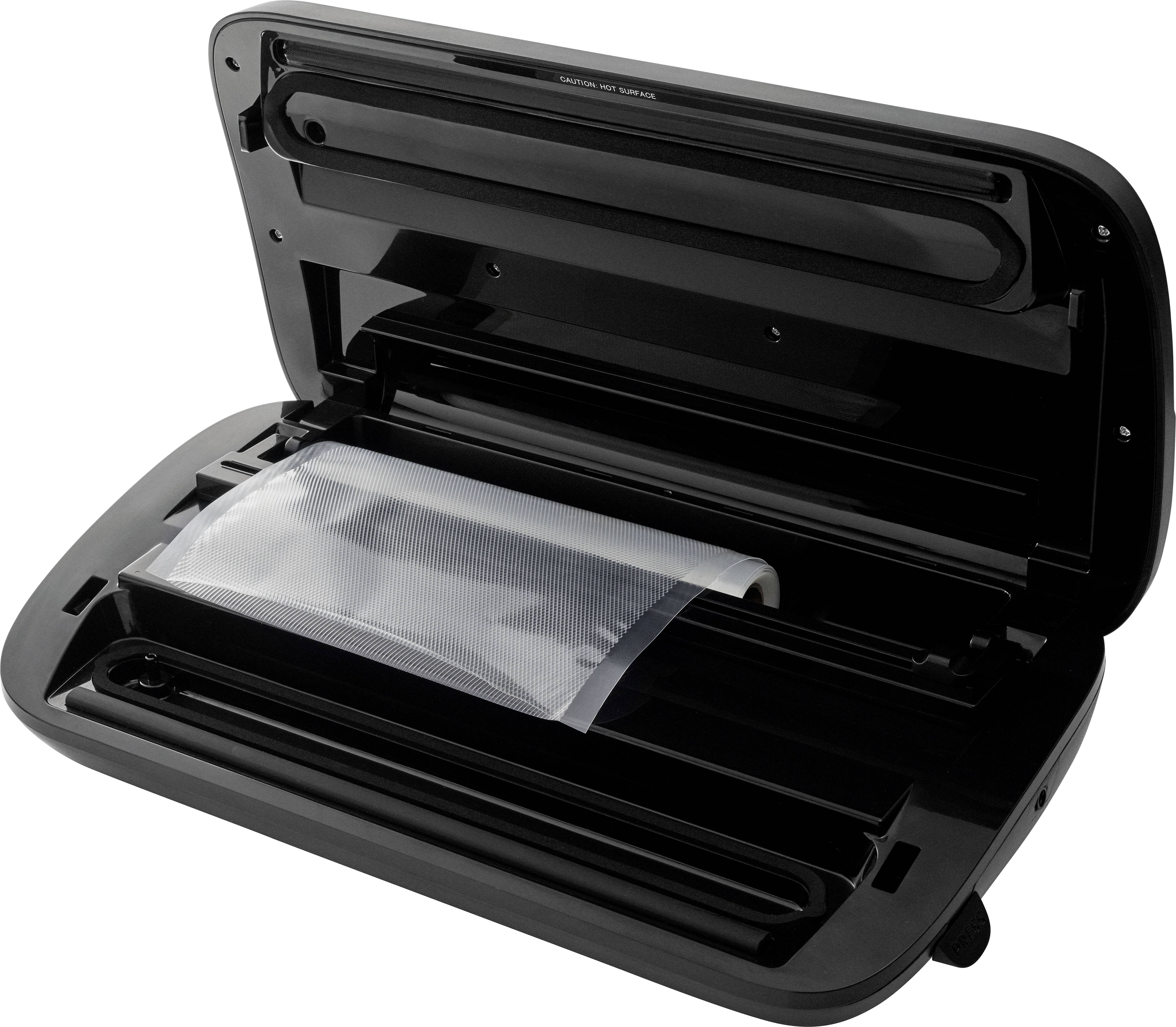 A vacuum sealer is open, revealing a partially sealed, transparent plastic bag inside.