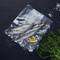 Three fresh fish in vacuum packaging with lemon slices and dill, decorated with salt on a black background.