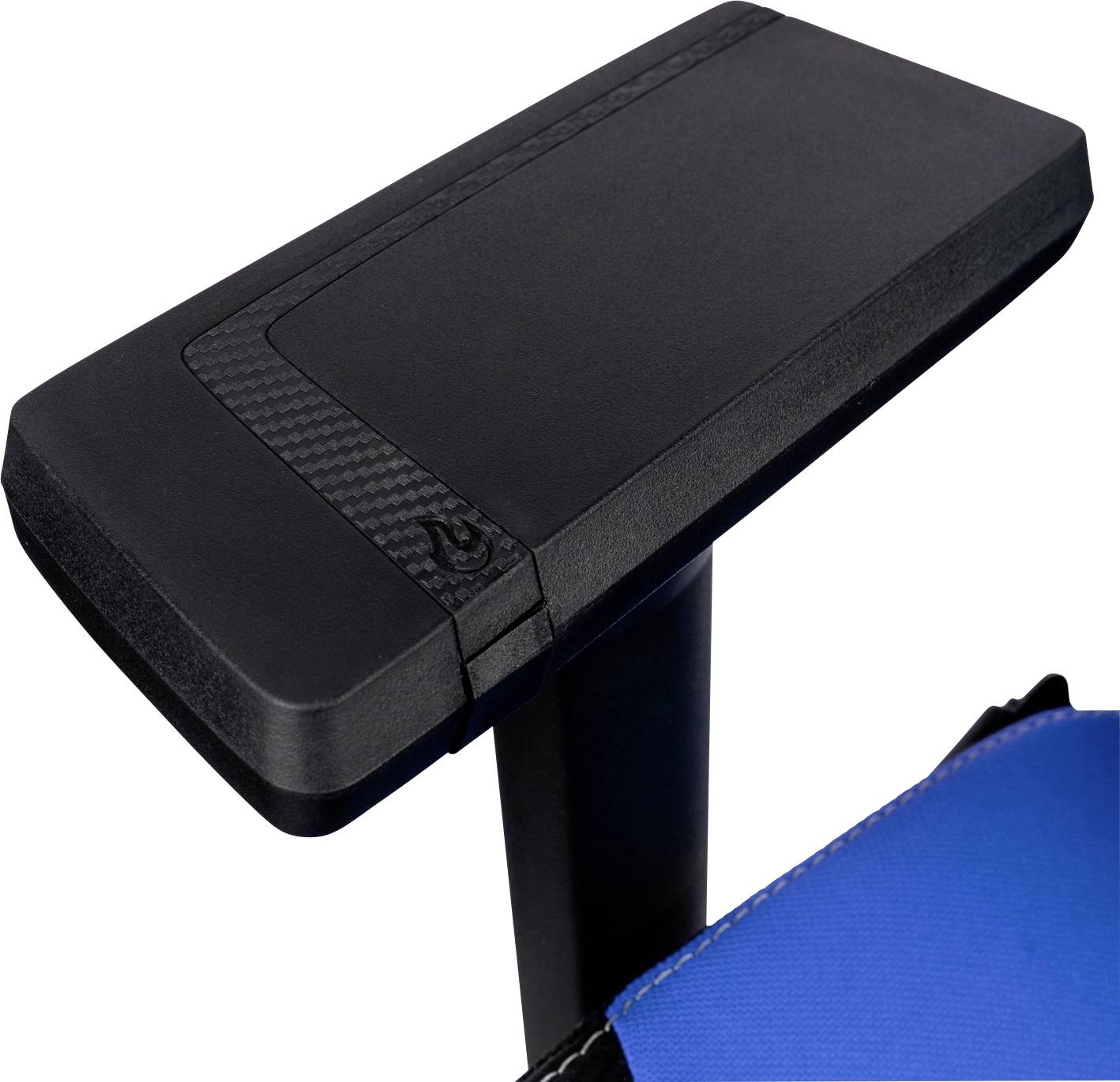 Armrest of a chair made of black plastic with a carbon detail, partially visible against a blue fabric background.