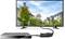 A monitor displays an image of trees and houses. The monitor is connected to an external device via a cable.