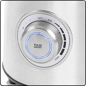 Silver rotary knob of a kitchen appliance with blue illumination. Markings for levels from 0 to Max, with 'PULSE ON/OFF' in the centre.