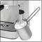 Espresso machine with steam wand, frothing milk in a metal jug.