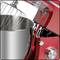 'Red stand mixer with lifting function. The machine's head can be raised to provide access to the mixing bowl.'
