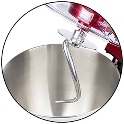 A silver dough hook in a mixing bowl, part of a red stand mixer. Ideal for kneading dough.