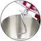 A silver dough hook in a mixing bowl, part of a red stand mixer. Ideal for kneading dough.