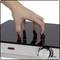 A hand carefully touches the smooth, black surface of a switched-on induction hob with a temperature control.