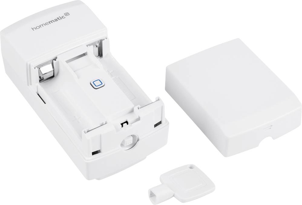 A white electronic device with its cover removed and a key beside it. The device appears to be a module.