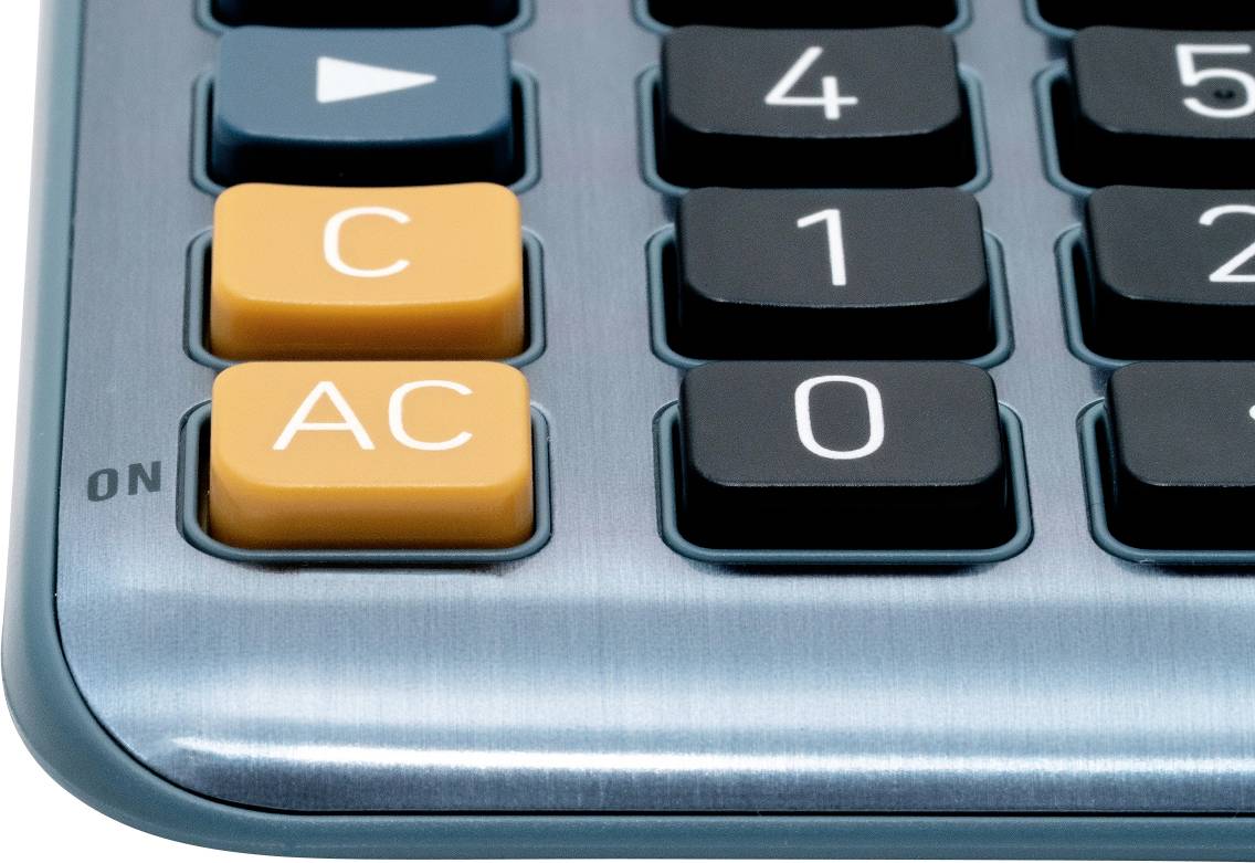 Keypad of a calculator with buttons for 'C', 'AC', numbers and a slide power switch.