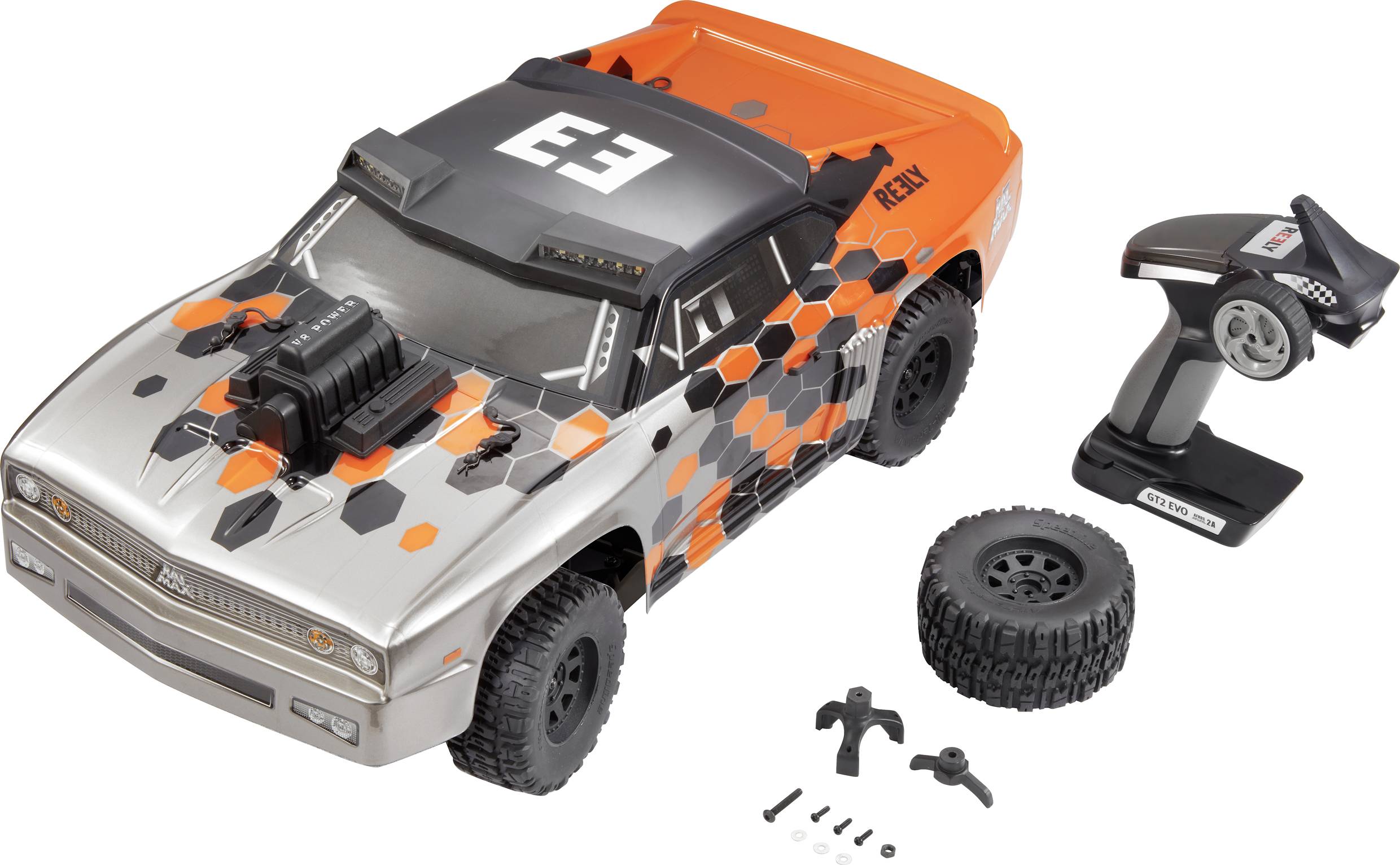 Remote-controlled off-road car in grey and orange, with spare tyres and accessories. Included remote control and toolkit.