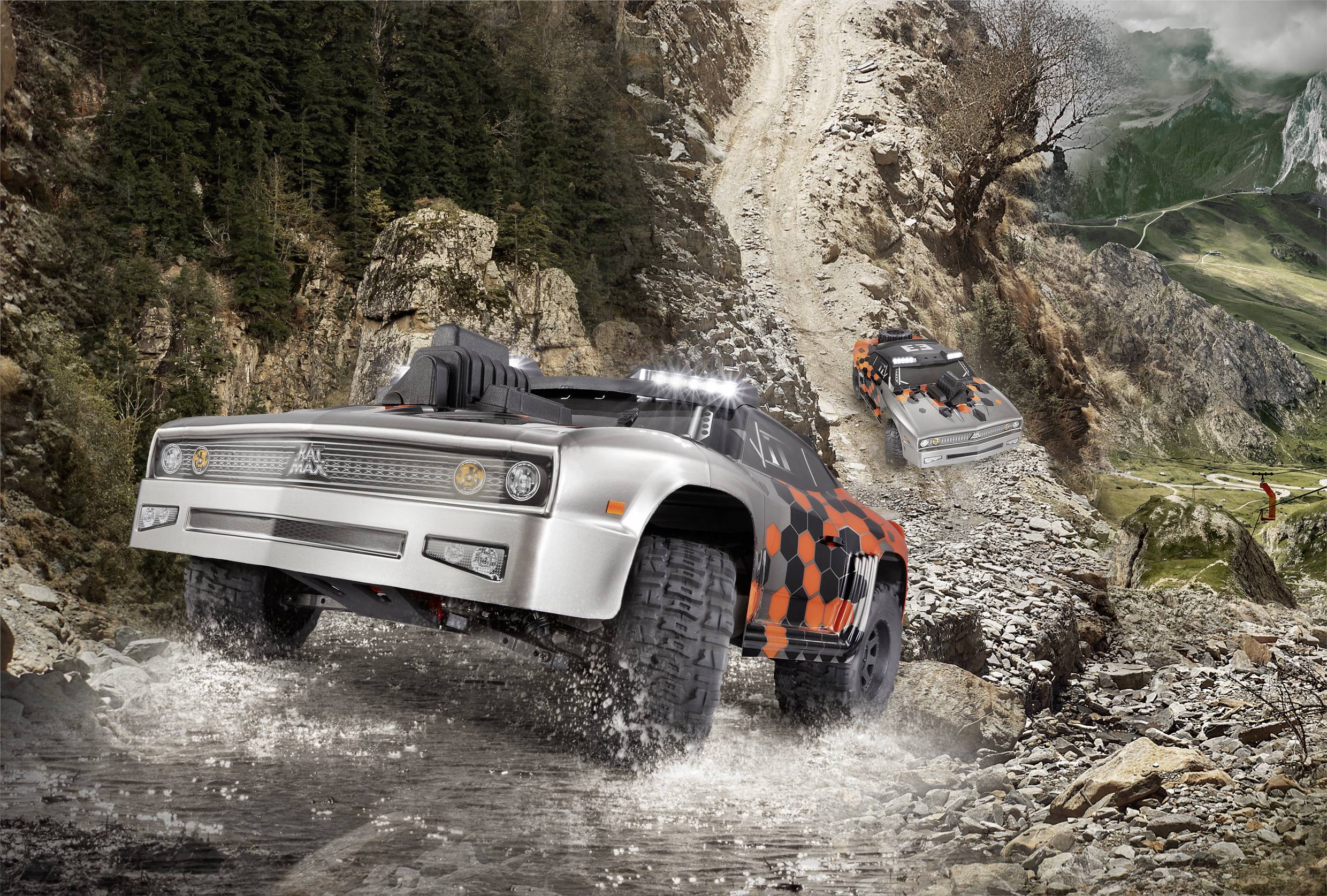 Two off-road vehicles are driving along a rocky mountain path. One is closer in the foreground, with the other visible further back.