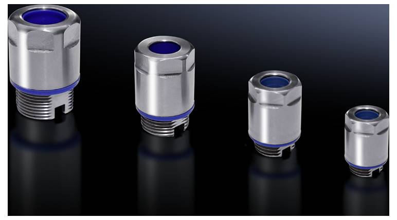 Four metal couplings in various sizes on a smooth, dark surface. They are cylindrical with blue seals.