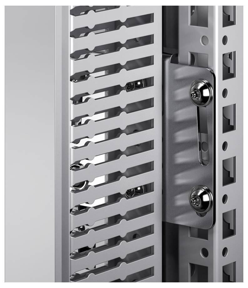 Close-up of a metal component with precisely punched openings and screws, likely part of an industrial control cabinet.