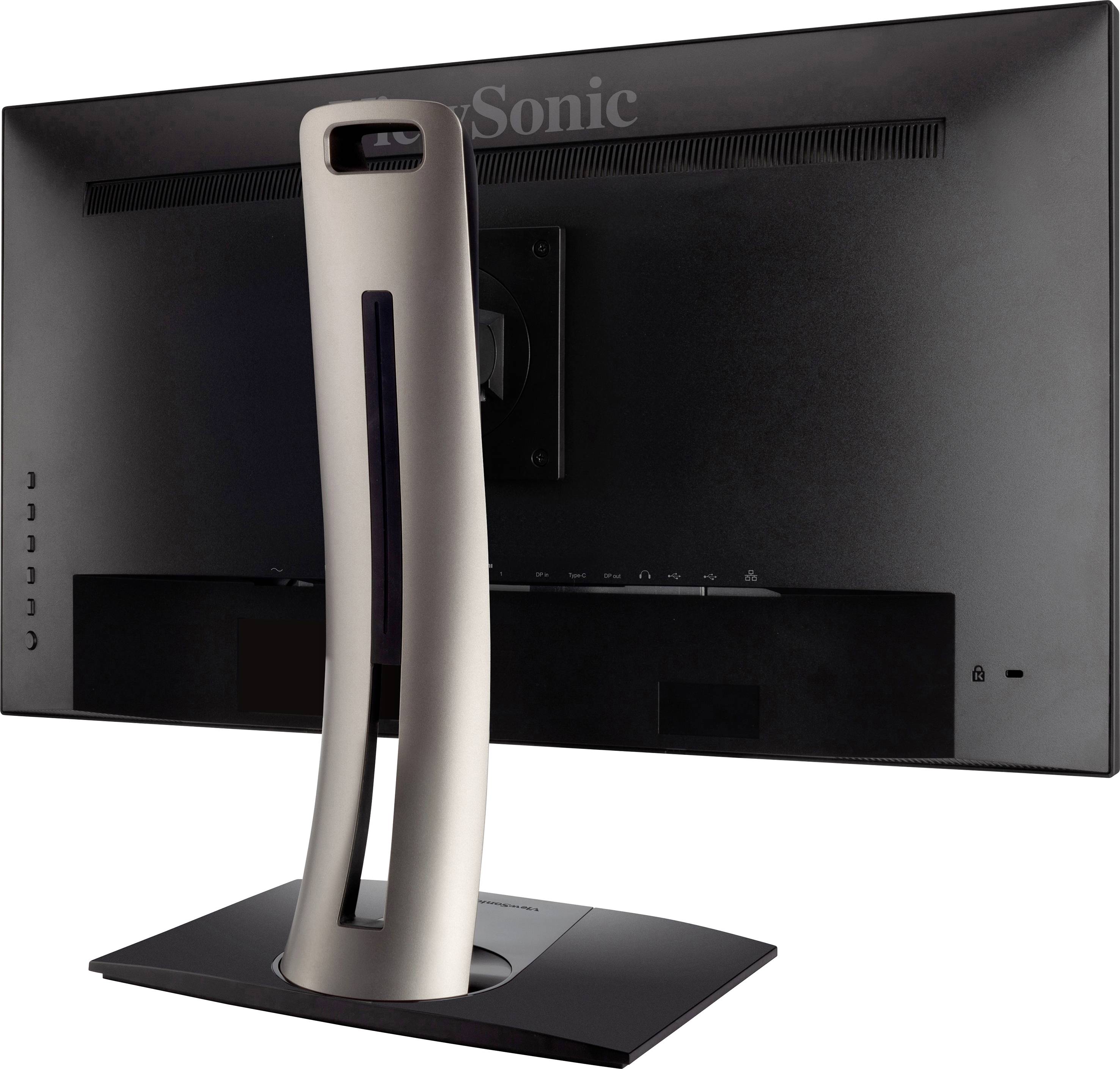 A computer monitor from a side rear view with a distinctive, curved metal stand and black casing.