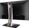 A computer monitor from a side rear view with a distinctive, curved metal stand and black casing.