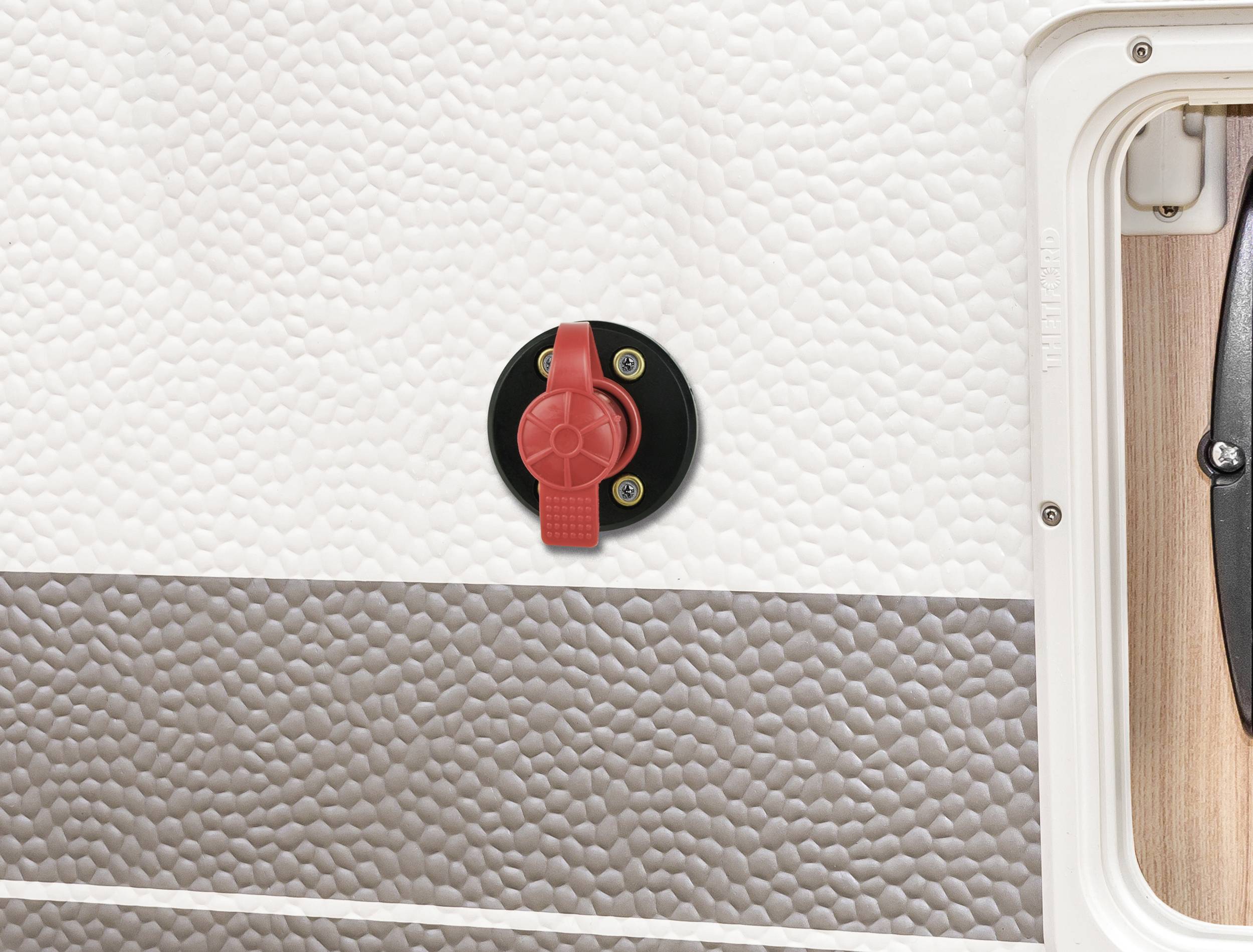 Battery isolation switch on the exterior wall of a motorhome to prevent electrical supply when not in use.