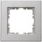 A square, metallic-looking frame with a central recess, suitable for mounting electrical switches or sockets.
