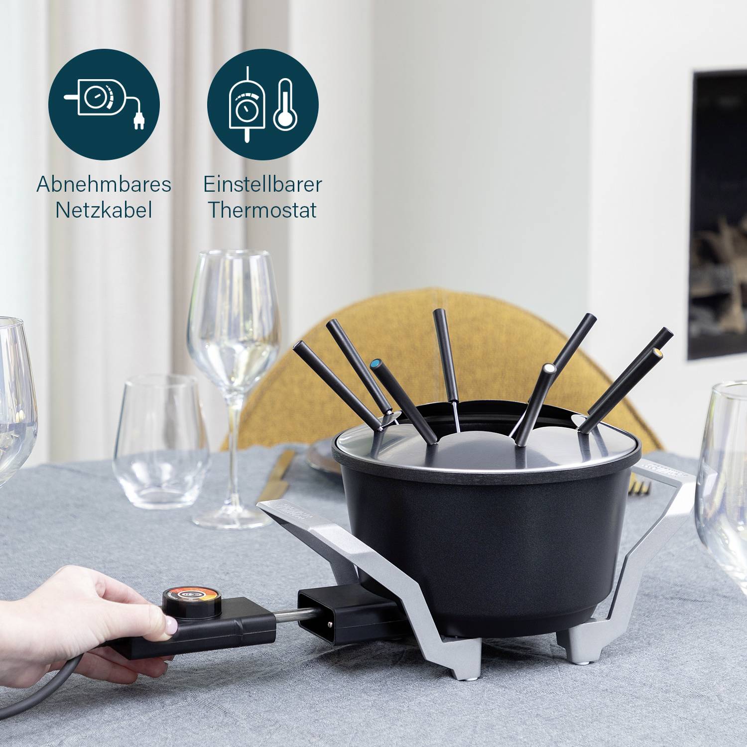Fondue set on a laid table, with adjustable thermostat and detachable power cord.