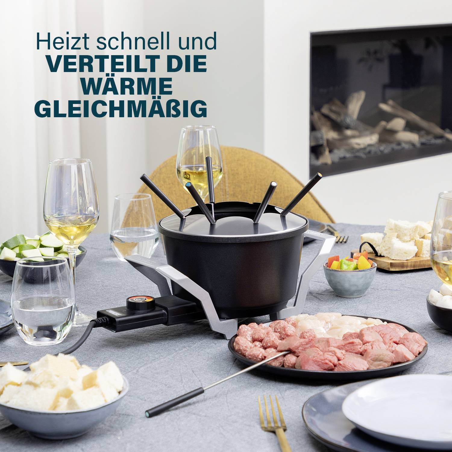 A table with a fondue set at its centre, surrounded by chopped vegetables, bread, meat and wine glasses. Top left reads: 'Heats quickly and distributes heat evenly'.