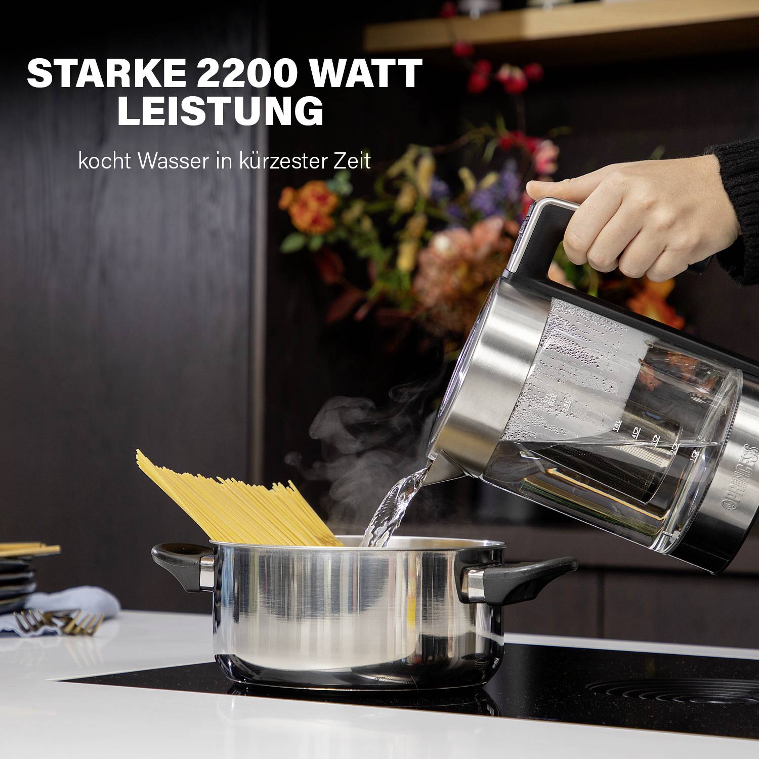 A hand pours water with a kettle into a saucepan of pasta. Colourful flowers in the background. Text 'Strong 2200 Watt Power'.